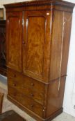 A Victorian mahogany linen press with two doors above two short and two long drawers to plinth base