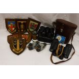 A pair of Karl Zeiss binoculars, various oak shields with Coats of Arms,