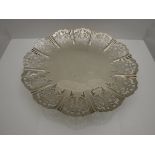 A George V silver fruit dish with lobed pierced foliate decoration raised on a circular foot (by