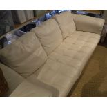 A modern cream leather upholstered three seat sofa