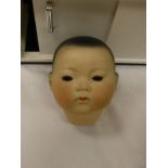 An Armand Marseilles oriental doll mould no 353/3½K with composition body,