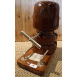 A wooden hat stretcher, bearing ivorine label inscribed with various measurements, size,