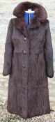 A dark brown squirrel fur full length coat,
