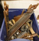 A box of various wood-working and other tools to include planes, blow torch, saws,