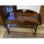 A mahogany drop side butlers tray in the George III manner raised on a plain stand