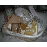 An Izzi Wotnot moses basket with stand, various gro bag baby sleeping bags, an Ella & Otto playmat,