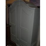 A duck egg blue painted twin two door armoire on a base of two drawers to bun feet