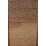 A late 18th Century sampler by Peggy Shaw dated 1783 worked with alphabet and floral sprays