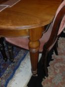 A late Victorian walnut D-end dining table of small proportions,