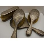 A silver-backed dressing table brush set,