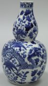 A Chinese blue and white gourd-shaped vase with four-toed dragon decoration,