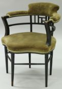 A Victorian Aesthetic ebonised framed armchair after a design by E W Godwin by Gillow & Co.