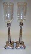A pair of circa 1900 silver plated hurricane lamp style candlesticks on Corinthian style columns to