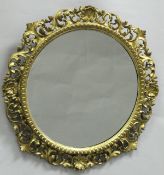 A 19th Century giltwood and gesso framed circular wall mirror of foliate pierced decoration in the