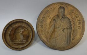 Two Eastern European carved treenware butter moulds, one depicting Christ with Cyrillic script, 15.