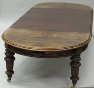 A Victorian Scottish mahogany extending 'D' end dining table and leaf cabinet,