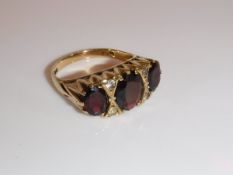 A 9 carat gold, garnet and diamond seed dress ring in the Victorian manner,