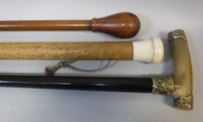 A late Victorian ebonised walking cane with horn handle and gold plated embossed scrollwork