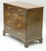 An early 18th Century quartered and cross and feather banded walnut bachelor's chest with fold-over