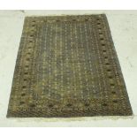 A modern Bokhara rug, the central panel with repeating medallion decoration on a grey/blue ground,