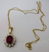 A 9 carat gold mounted ruby and diamond cluster pendant,