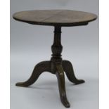 A late 18th Century oak tea table, the circular snap top on a turned vase shaped pedestal,