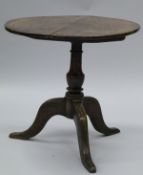A late 18th Century oak tea table, the circular snap top on a turned vase shaped pedestal,