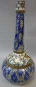 A Persian Qajar Dynasty pottery vase of onion form, the slender neck decorated with flowers,