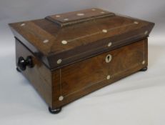 An early 19th Century rosewood jewellery casket of sarcophagus form with pewter strung and mother