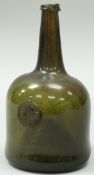 An 18th Century black glass sealed wine bottle of mallet form, inscribed "Coll John Folliott 1743",