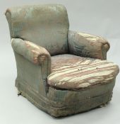 A Victorian armchair with deep horse hair seat and turned front legs to black china castors