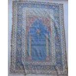 A Turkish prayer rug, the central panel set with Mihrab design on an orange and teal ground,