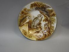 A 19th Century plate hand-painted with four various owls amongst trees with hare prey,