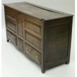 An 18th Century North country oak mule chest the plank top with moulded front edge above the five