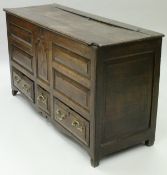 An 18th Century North country oak mule chest the plank top with moulded front edge above the five