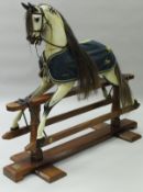A Stevenson Brothers rocking horse in dapple grey with real hair mane and tail,
