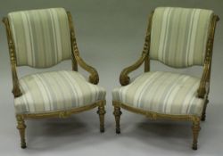 A pair of 19th Century fauteuils French Louis XV style salon chairs with giltwood carved frames,