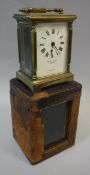 A circa 1900 brass carriage clock with Roman numerals to the enamelled dial,