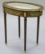 A 20th Century Louis XVI style mahogany bijouterie table of oval form,