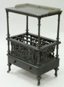 A Victorian ebonised canterbury, the top section with brass gallery to turned and fluted supports,