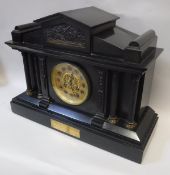 A Victorian black slate cased mantle clock of architectural form,