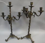 A pair of patinated bronze adjustable candelabra in the Arts & Crafts taste,