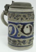A 19th Century Westerwald tankard with relief work blue ground decoration and pewter lid, 17.