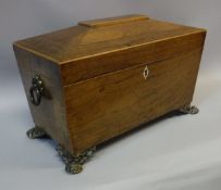 An early 19th Century rosewood tea caddy of sarcophagus form with boxwood inlaid decoration,