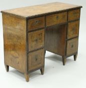 An 18th Century Continental walnut and banded kneehole desk with moulded edge and nine drawers,