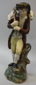 An early 19th Century Staffordshire pearl ware figure group of a shepherd with sheep upon his