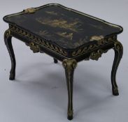 A 20th Century lacquered chinoiserie style tray table in the 19th Century manner with gilded scenes
