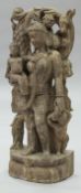 An Indian carved stone figure of Mother and Child in her arms with further child at her feet