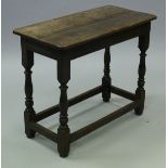 An 18th Century oak side table, the two plank top above a plain frieze,