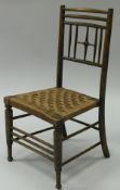 A late Victorian Aesthetic stained beech framed child's chair in the manner of Liberty Argyle,